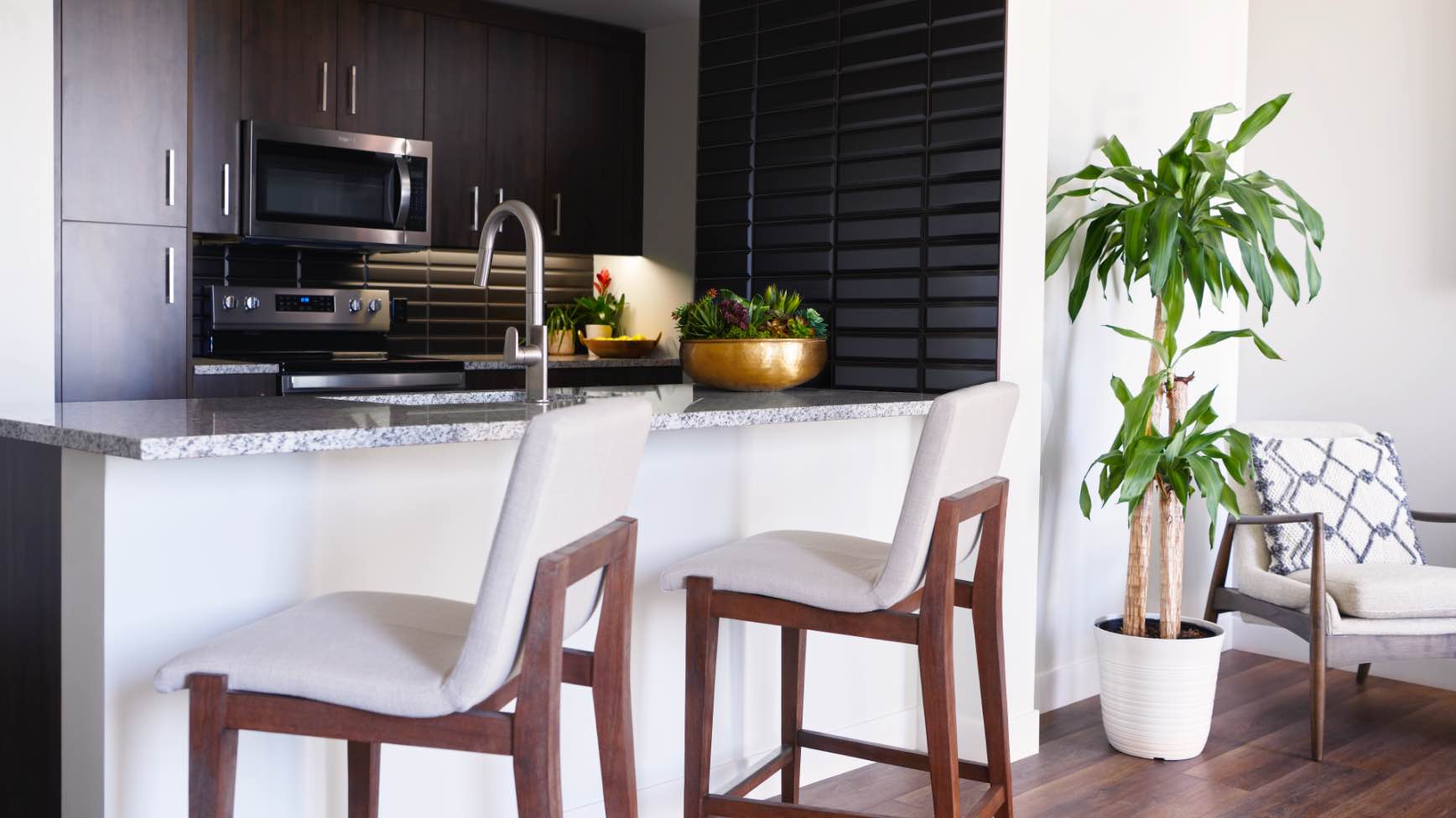 two white bar stools looking into a kitchen