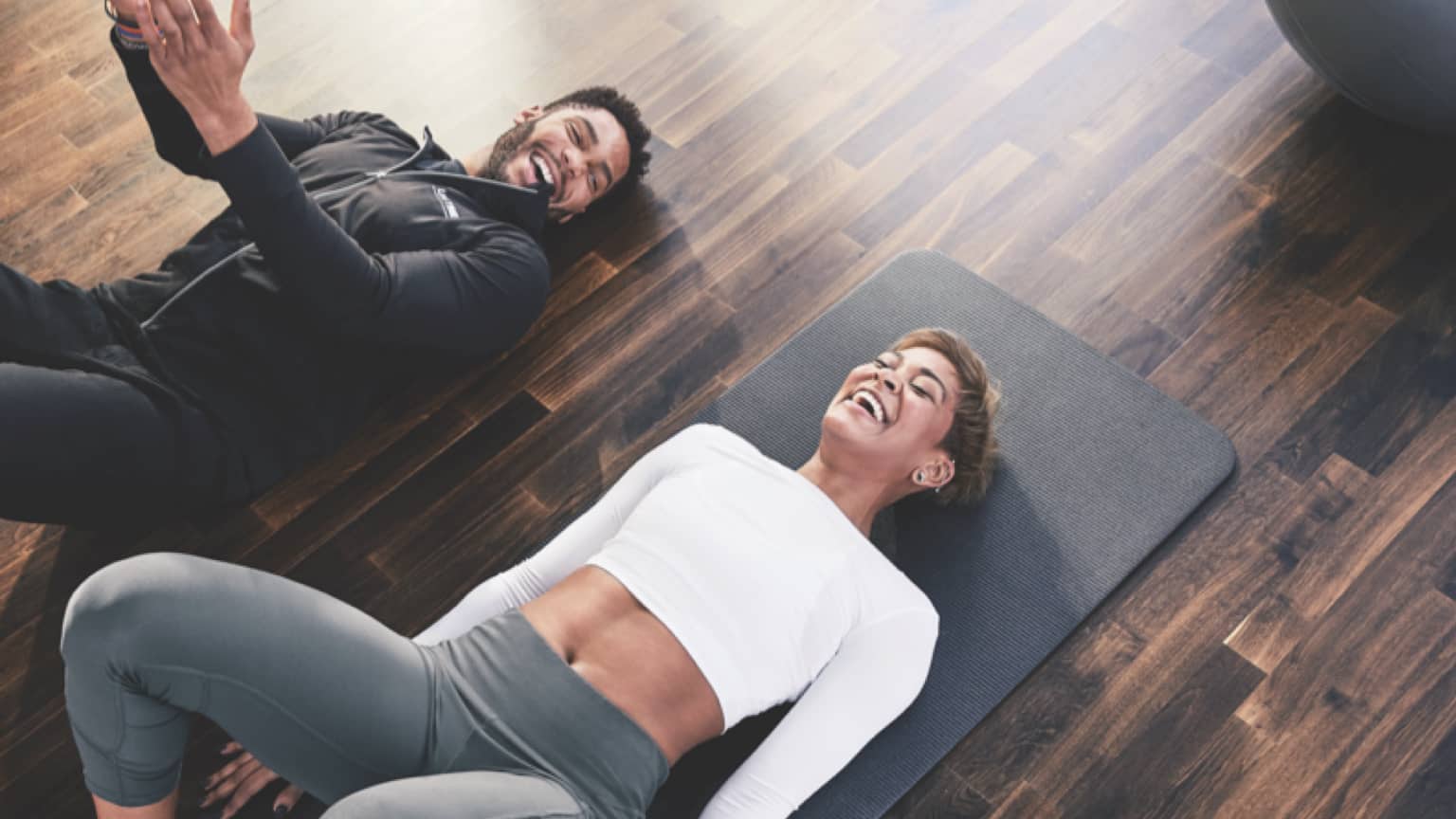 A personal trainer works with a Life Time Living resident at a Life Time Athletic Resort and Spa