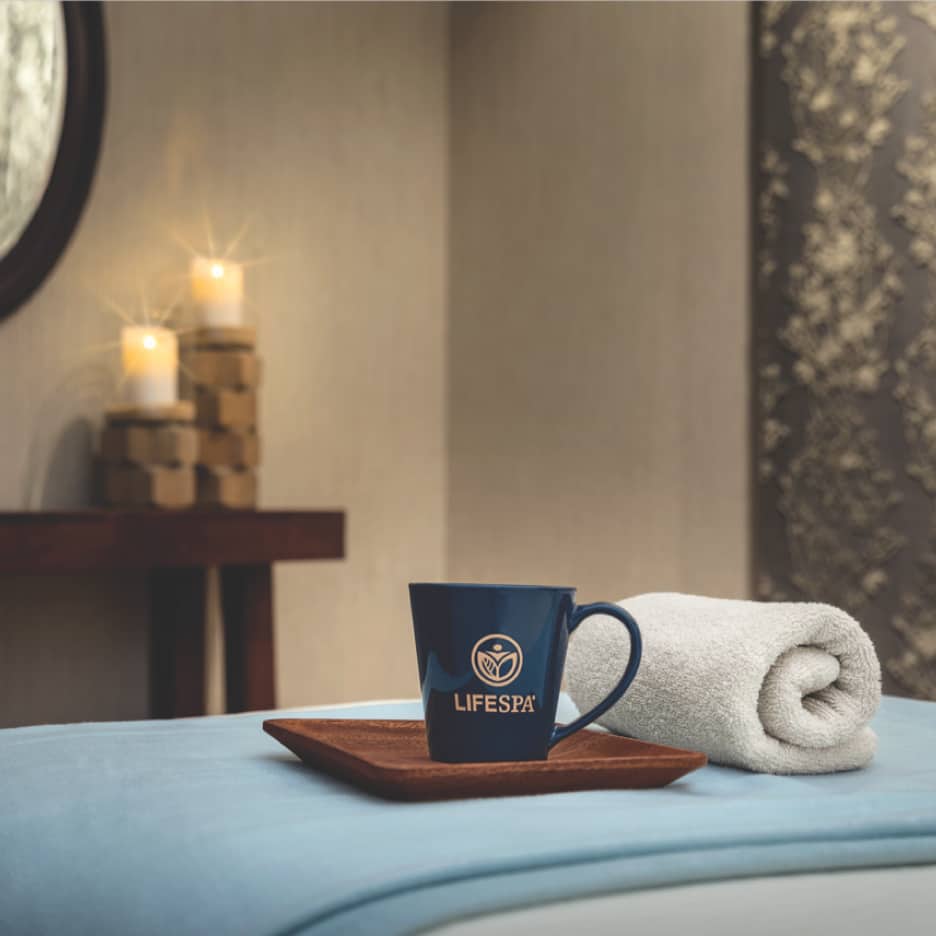 A cup and saucer sit on a massage table in the LifeSpa