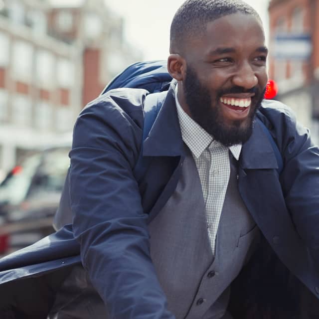 Man smiling while riding a bike in Coral Gables, Florida