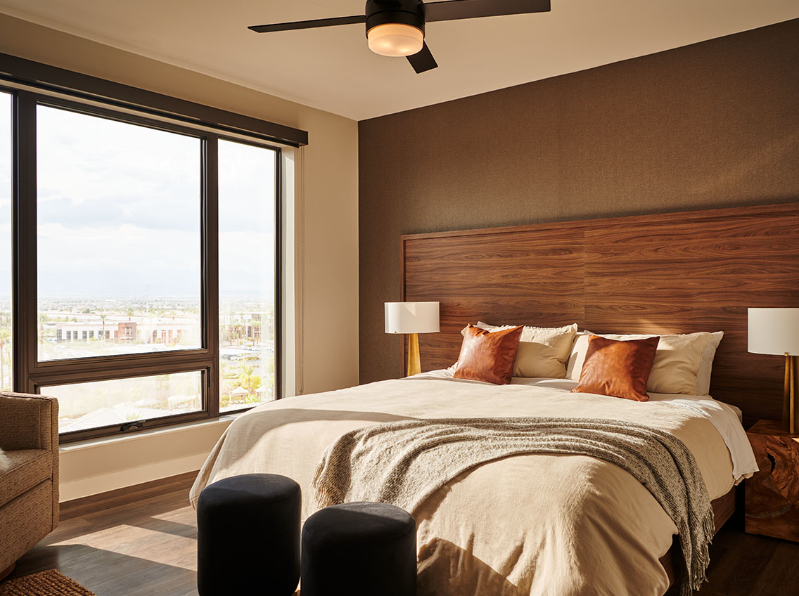 photo of bedroom with queen size bed with gray comforter and pillows